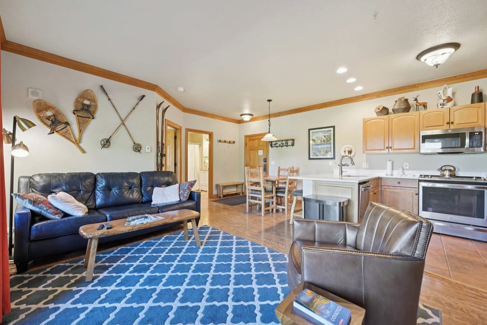 Relax in your mountain-inspired living space with leather seating, a fully equipped kitchen, and charming rustic touches throughout.