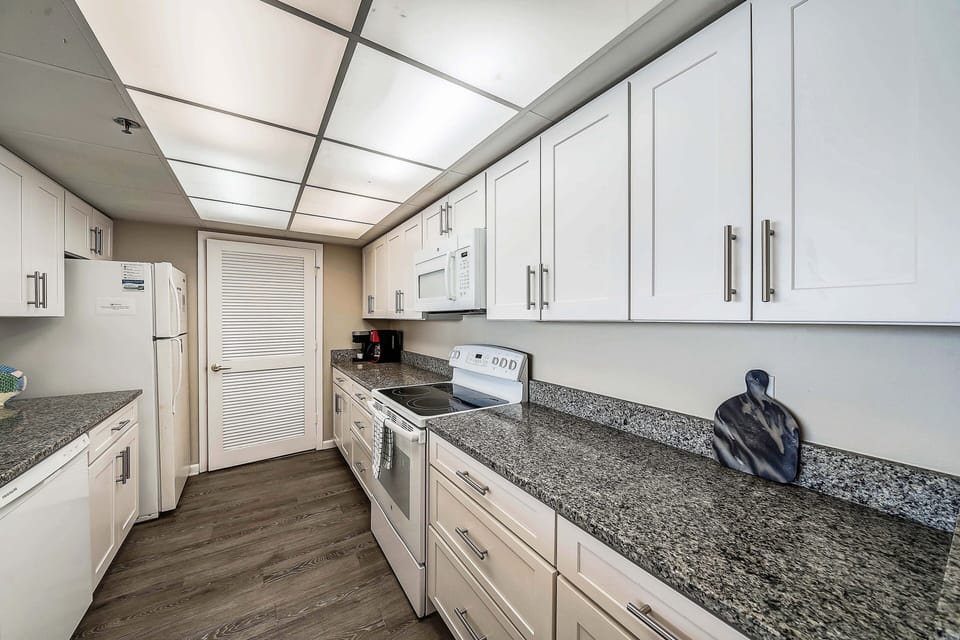 The fully equipped kitchen features granite countertops and has everything you need to prepare meals for family & friends.