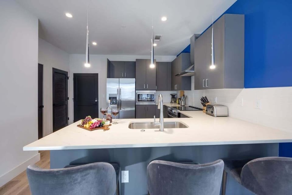 Fully equipped kitchen stocked with your basic cooking essentials, stainless-steel appliances, and breakfast bar seating.