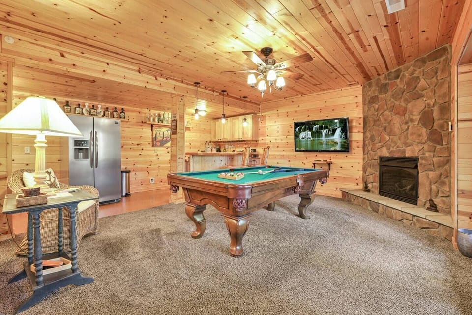 Basement hangout area - features pool table, fireplace, bar area and TV.