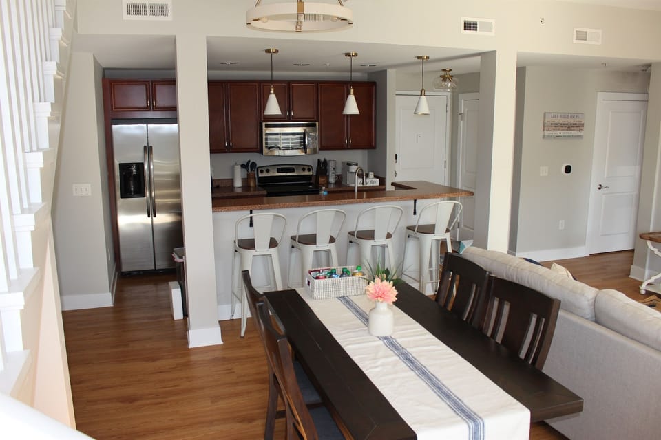 Dining area and fully equipped kitchen with toxin-free cookware. Seating for 4, with an additional 4 at the counter (or a couple on the balcony), complete with select spices and everything you need for real meals.
