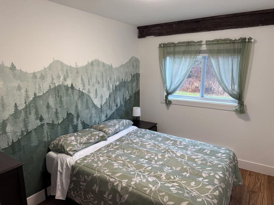 Bedroom 2, with double bed and backyard view.