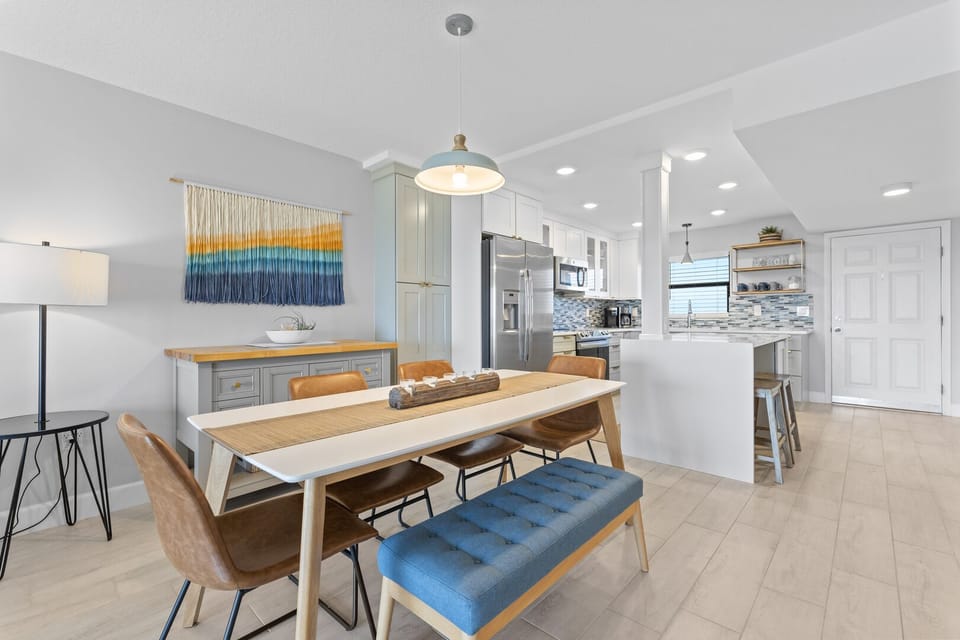 Open dining space with a beachy aesthetic seats six, perfect for gatherings.