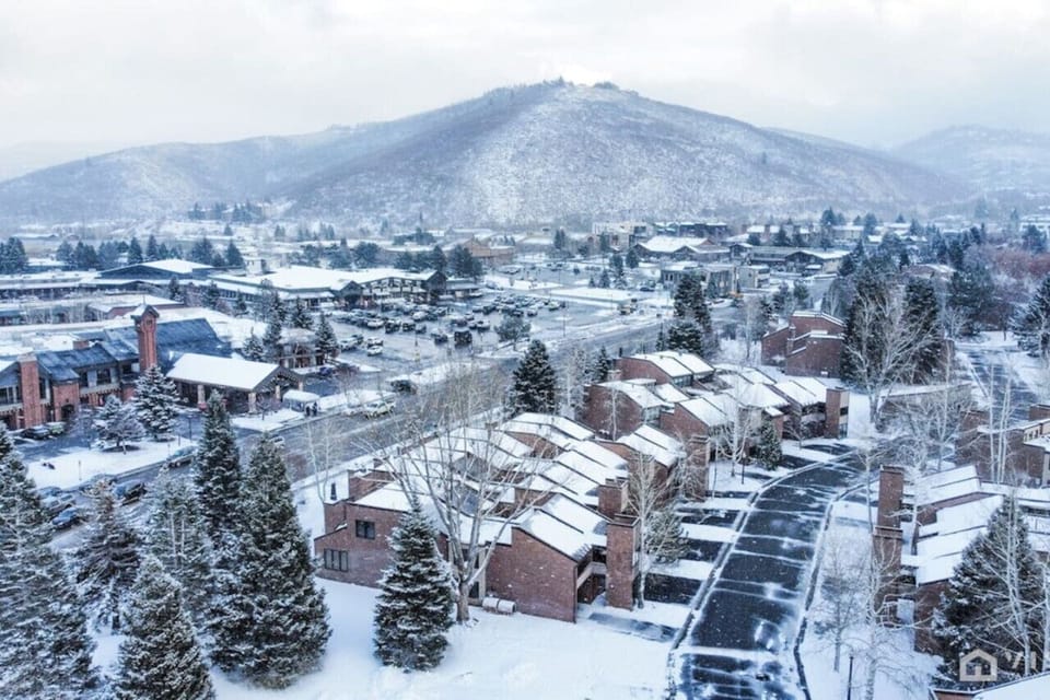 The condo offers a cozy, inviting atmosphere, set against a serene snowy backdrop, perfect for winter getaways.