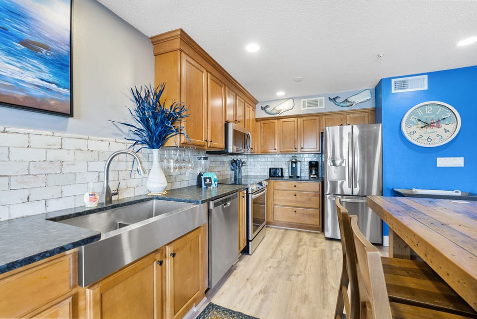 Your fully equipped kitchen features warm wood cabinets, granite counters, and stainless appliances for memorable home-cooked meals.