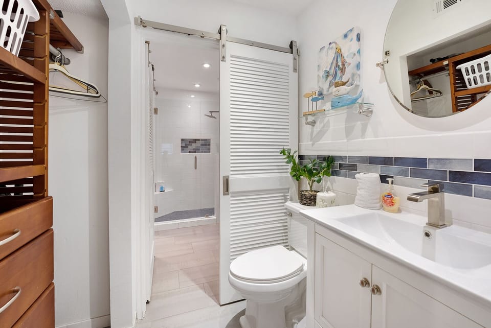 Refresh in your beautifully tiled bathroom with spacious shower, modern vanity, and thoughtful storage throughout.