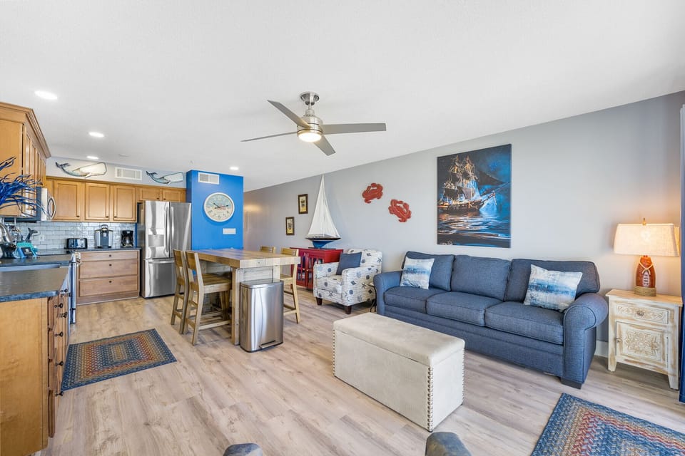 Relax in your nautical-themed retreat where ocean blues meet coastal comfort. Your open-concept space flows seamlessly from kitchen to living area.