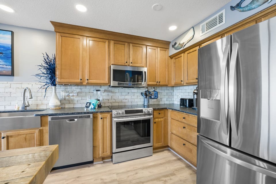 Your fully-equipped kitchen awaits with granite counters, stainless appliances, and everything needed to create memorable meals during your stay.