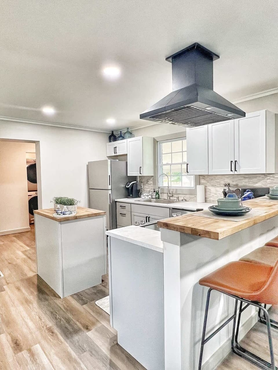 Open kitchen with island and stainless appliances.