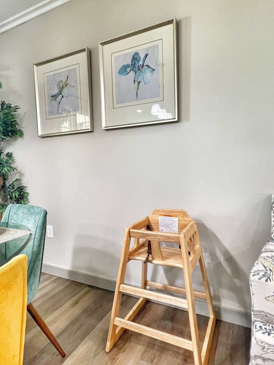 Dining area corner with accent wall and high chair available upon request.