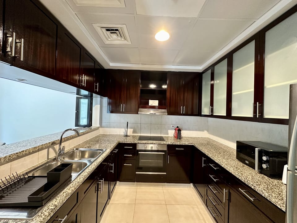 Exclusive Apartment | Private kitchen | Full-size fridge, microwave, oven, stovetop