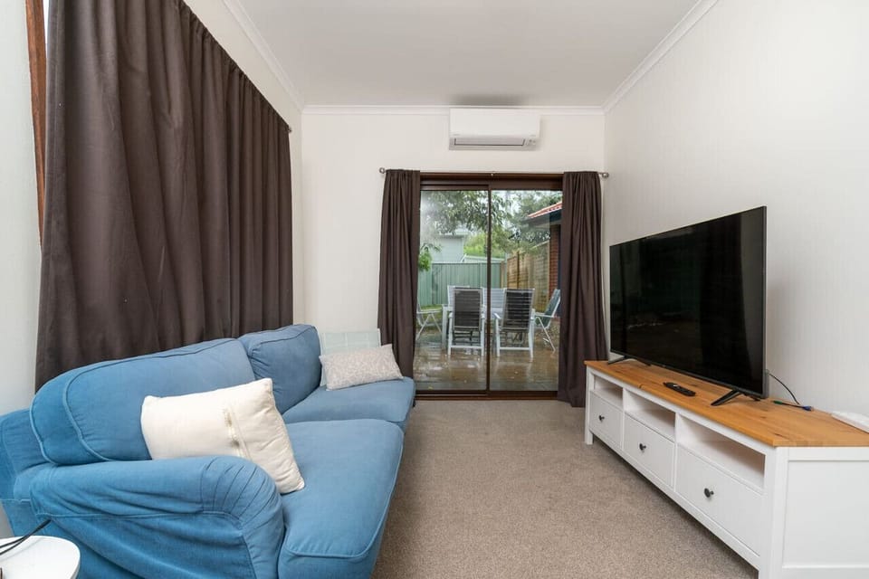 Simple and inviting living room featuring plush furniture and a snug atmosphere, ideal for unwinding.