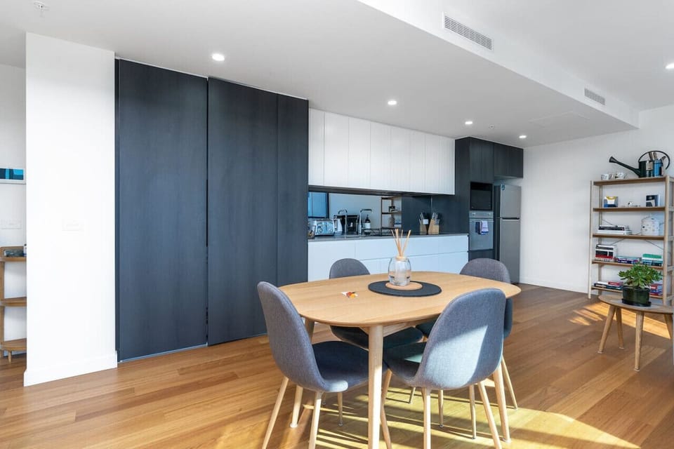 This open-plan dining area showcases a modern 4-seater table, providing a spacious and welcoming setting for enjoying meals and making memories.