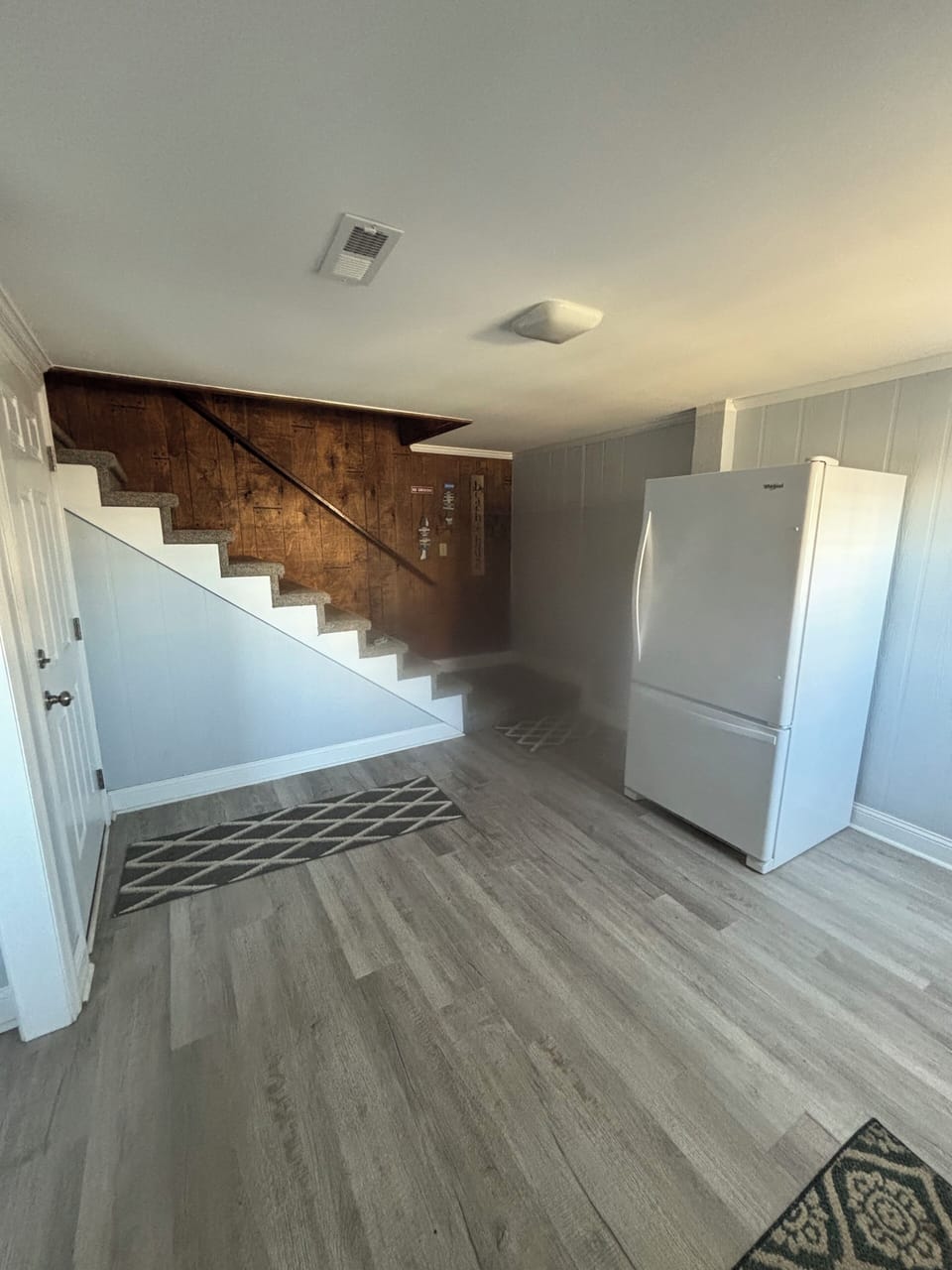 Foyer coming into home with extra refrigerator