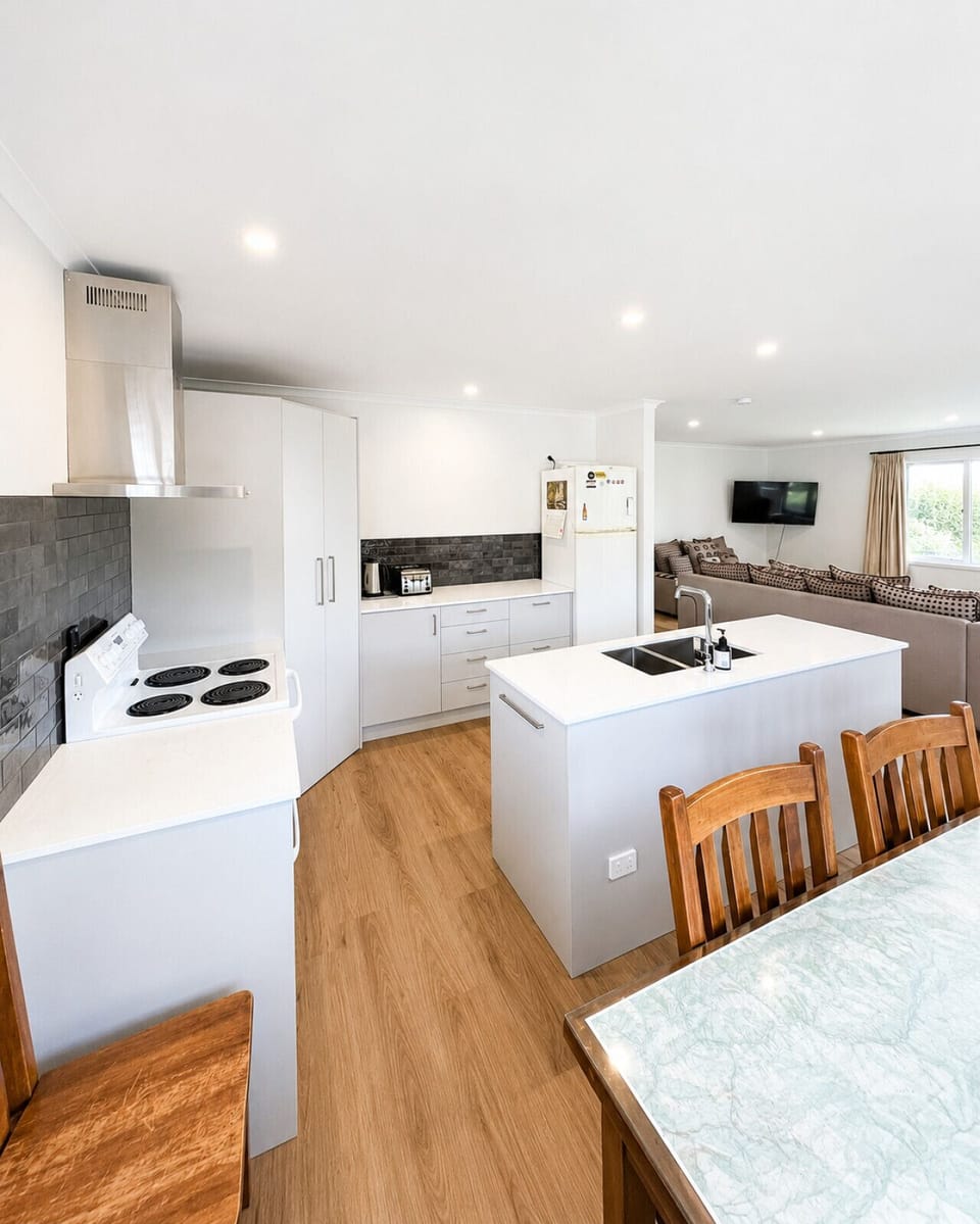 Fully equipped kitchen flowing into relaxed living area