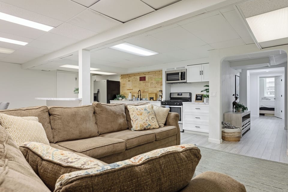 Spacious family room w/ plush sectional & open layout to kitchen.