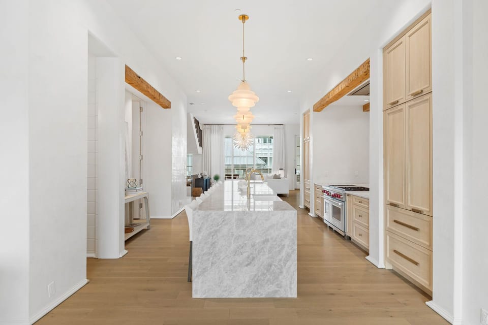 3 Full Sized Kitchen sinks, 2 Dishwashers, Brass fixtures, Taj Mahal Quartz Countertops, Venetian Plaster Walls, European White Oak Counter Tops.