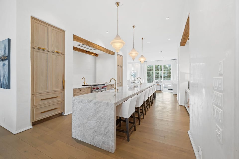 The Second floor Main Level consists of front and back living rooms, framing a Gourmet Kitchen complete with an Expansive Island, Three separate Sinks and Dishwashers, and a Dedicated Coffee and Wine bar.
The Back living room leads out to the Private pool and Fireplace Area.