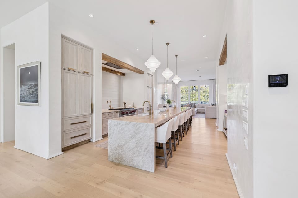 The 2,000 SqFt Main Level consists of front and back living rooms, framing a Gourmet Kitchen complete with an Expansive Island, Three separate Sinks and Dishwashers, and a Dedicated Coffee and Wine bar.