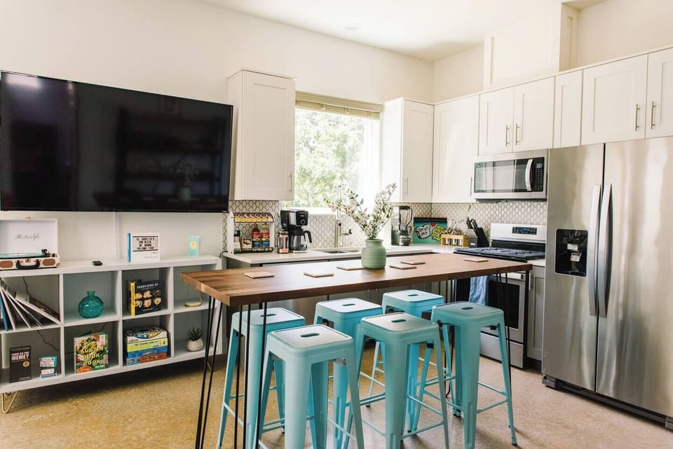 The kitchen has all new stainless appliances. The butcher block bar height table acts both as an indoor dining space and extra prep space