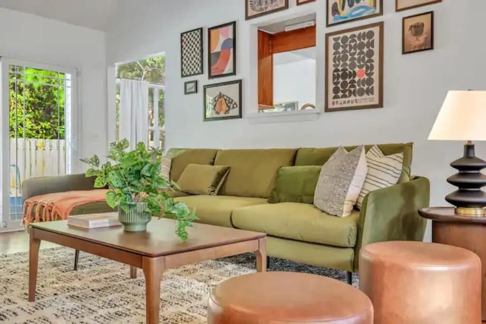 Chic living room with plush seating, a gallery wall, and a 55" smart Roku TV.
