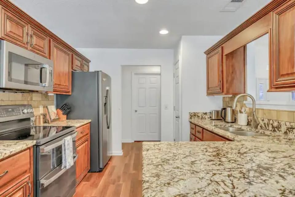 Spacious kitchen with stainless steel appliances and ample counter space.