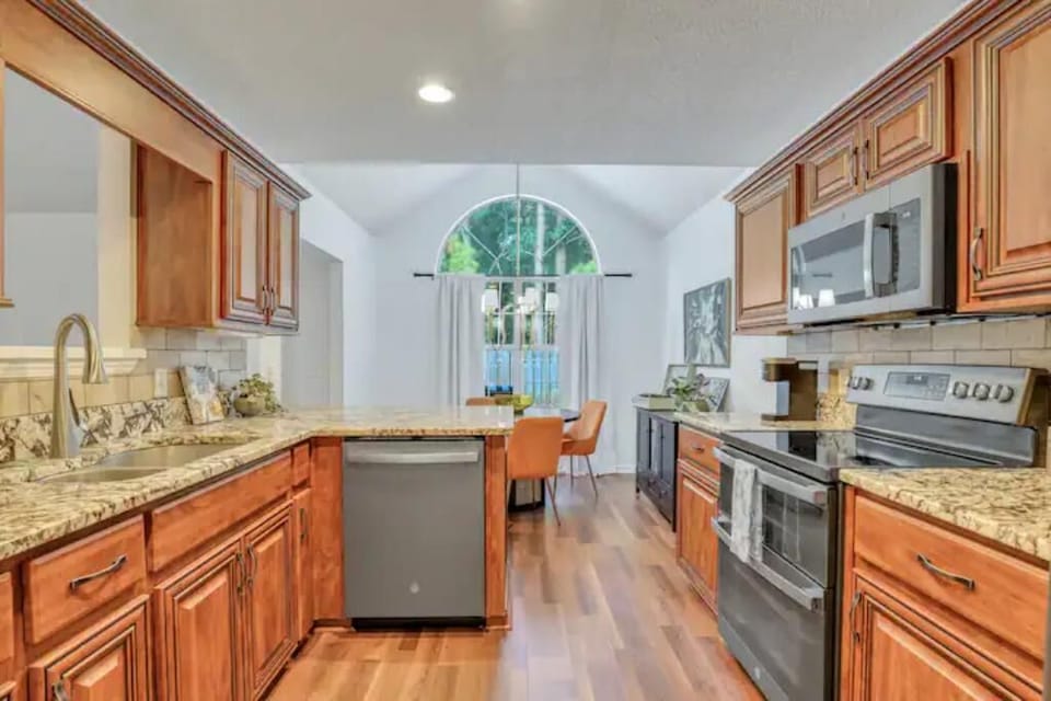 Spacious kitchen with stainless steel appliances and ample counter space.