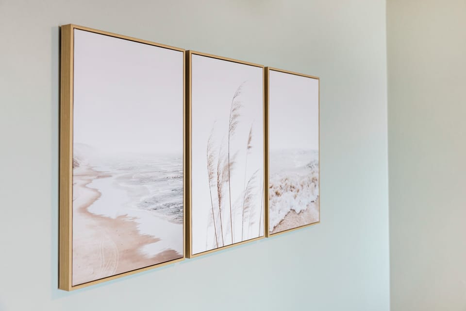 Soft coastal artwork creates a serene atmosphere in your space, featuring gentle beach scenes that bring tranquil seaside vibes indoors.