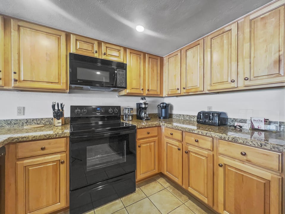 Kitchen features a toaster and coffee maker.