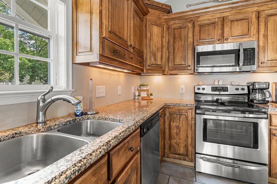 Cozy kitchen with granite counters and stainless steel appliances