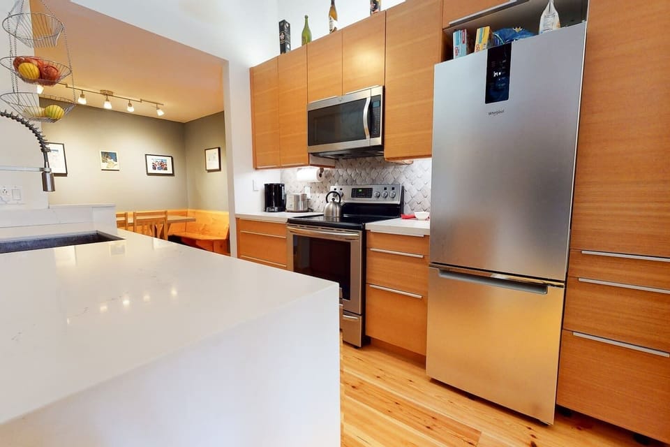 Pantry to the right of the stainless fridge for food storage. 