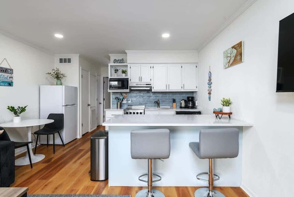 A large peninsula extends from the kitchen, offering a casual dining spot.