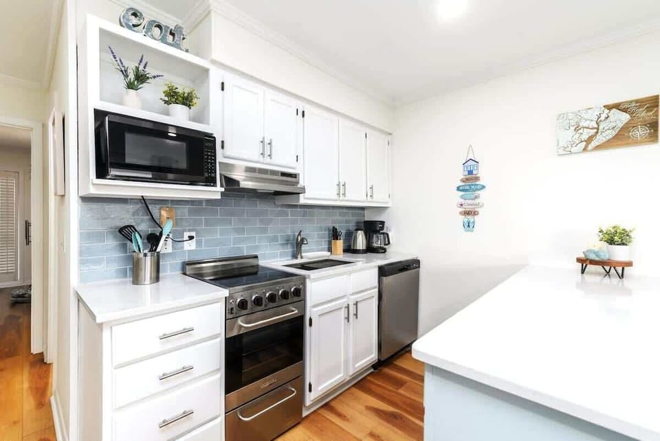 The suite is fully equipped with stainless steel and white appliances.