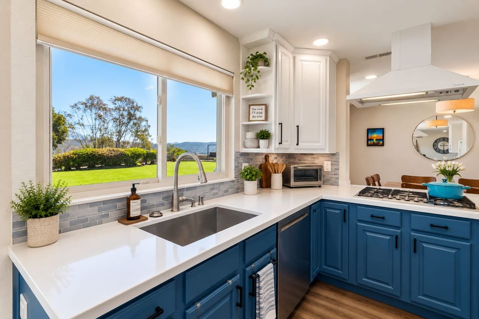 Chef’s kitchen with gas cooktop, island, and statement hood