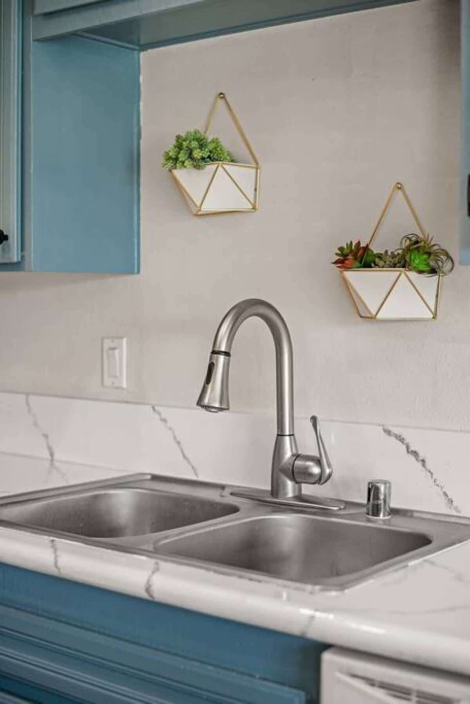 Modern double sink with stylish tile backsplash and fresh decorative touches