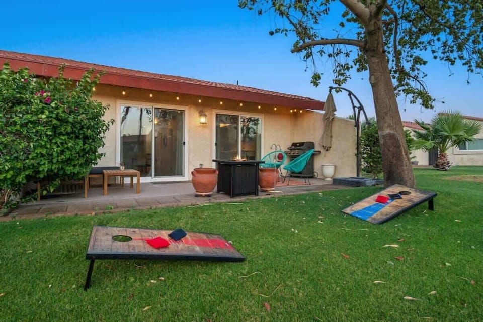 Take a step outside and play some cornhole in the desert evening.