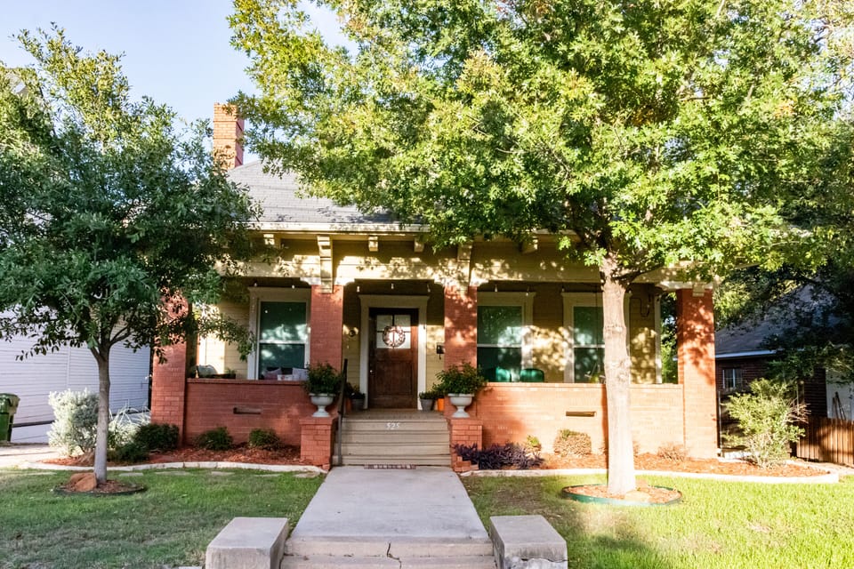 Front of house with driveway on the left and stone path to driveway
