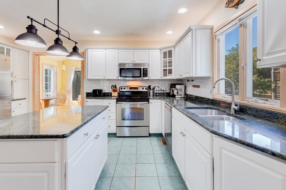 The spacious open-concept Kitchen has all the modern appliances you need for seamless prep and cleanup.