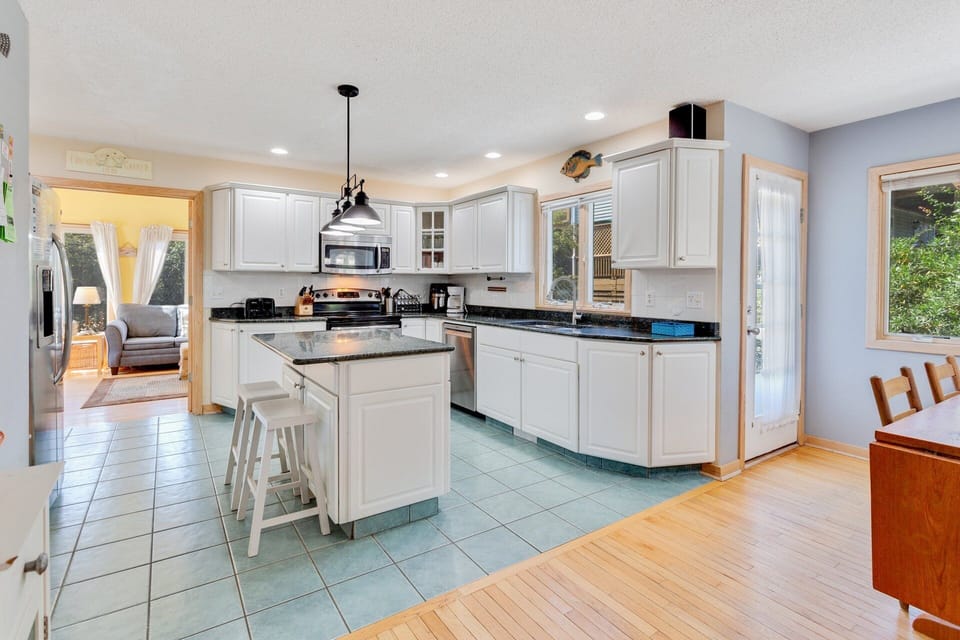 The spacious open-concept Kitchen has all the modern appliances you need for seamless prep and cleanup.