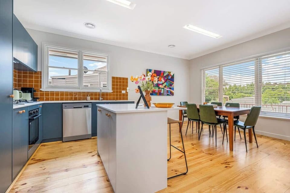 Light-filled kitchen and dining space with enough seating for all guests.