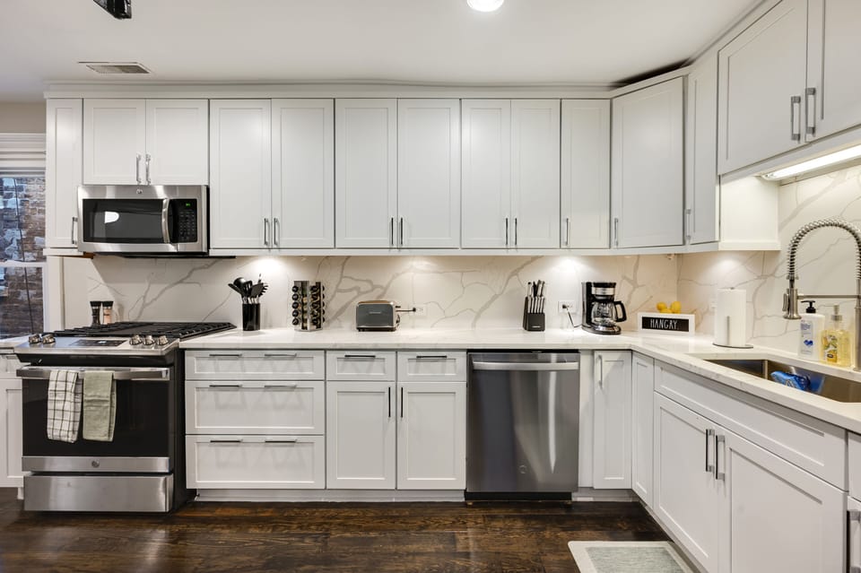 Main kitchen with quartz counters/backsplash with all new appliances! 