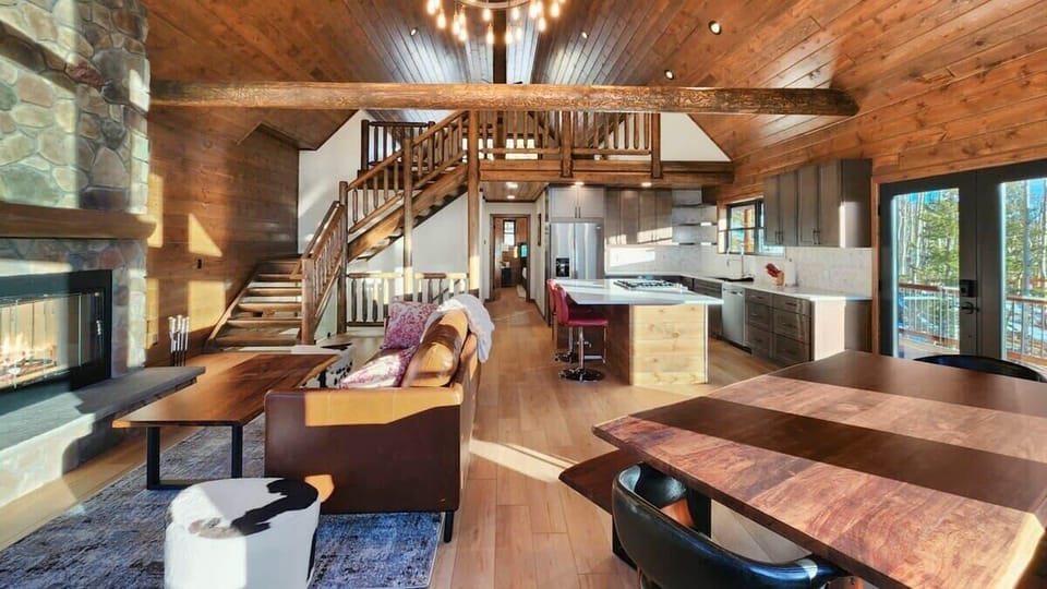 The view over the main level of the home where you will find the living room, kitchen, and dining room in an open and social layout.