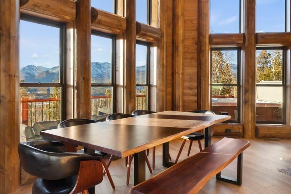 Next to the kitchen is the dining area where you will find a lovely wood table with seating for 8 and french doors opening out to the deck.