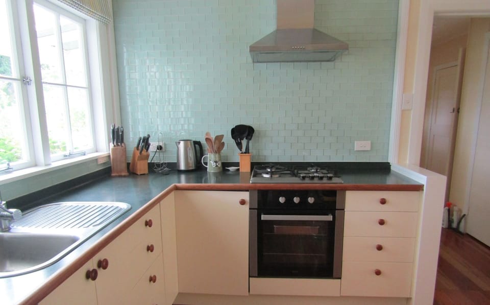 Kitchen with gas hob, electric oven and dishwasher.
