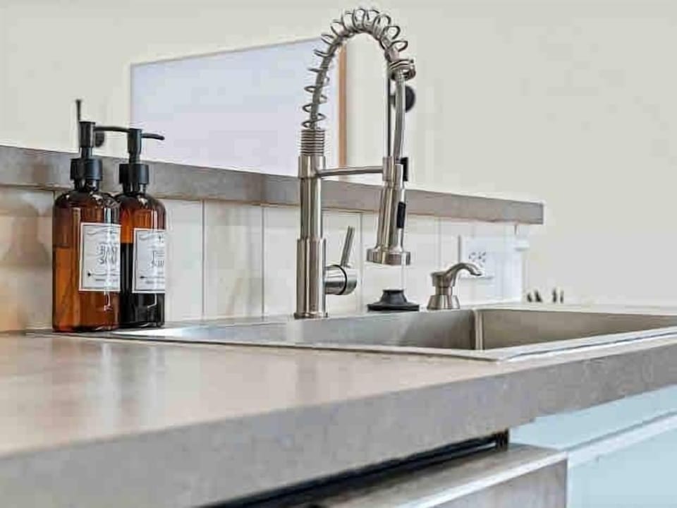 Elevate your cooking and cleaning routine with our generously sized sink, featuring convenient soap and hand wash stations.