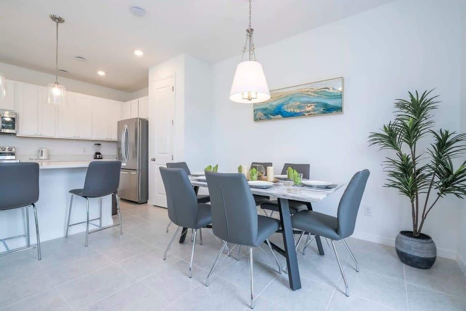 Gather for a home-cooked meal in the modern dining area. This sleek space features seating for six and opens directly into the fully equipped kitchen.