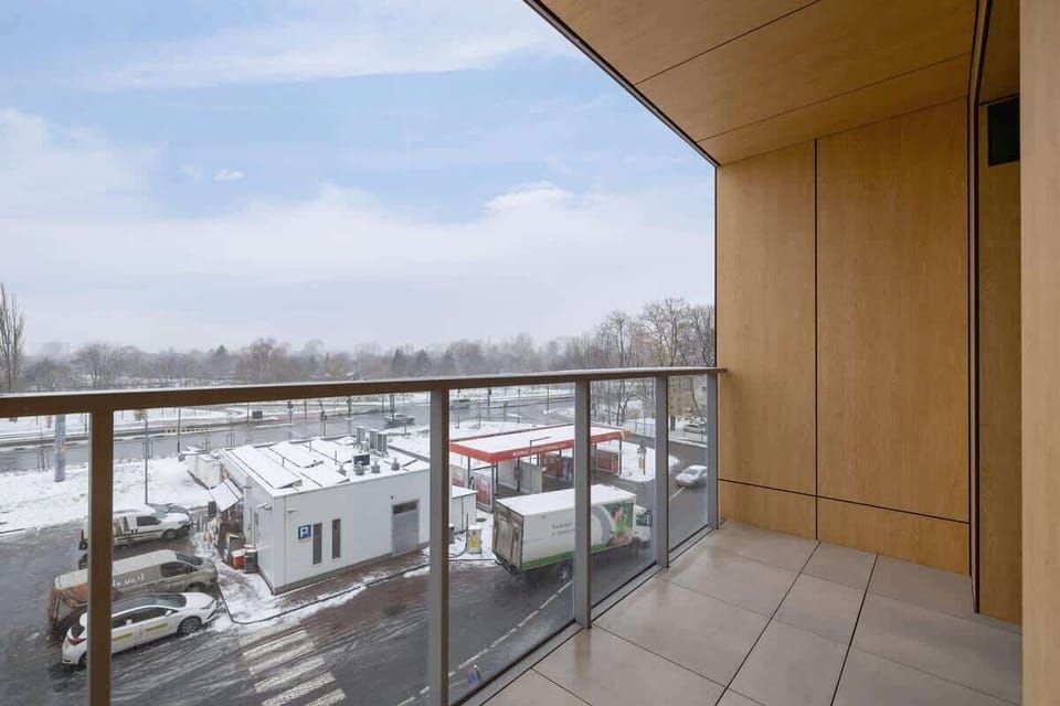 The balcony's stylish design complements the apartment's decor. 