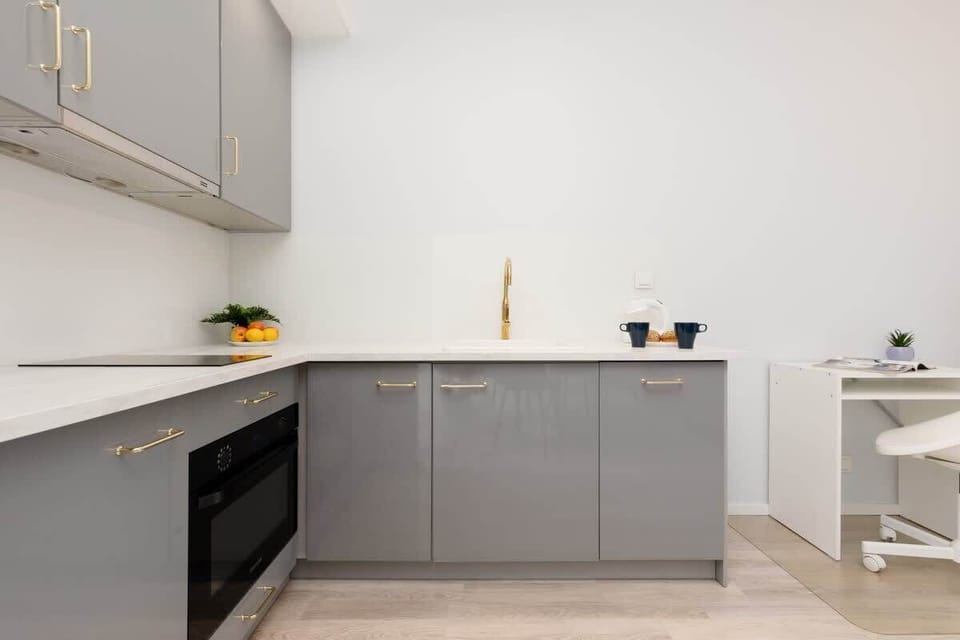 The sleek design of the kitchenette blending seamlessly with the living area.