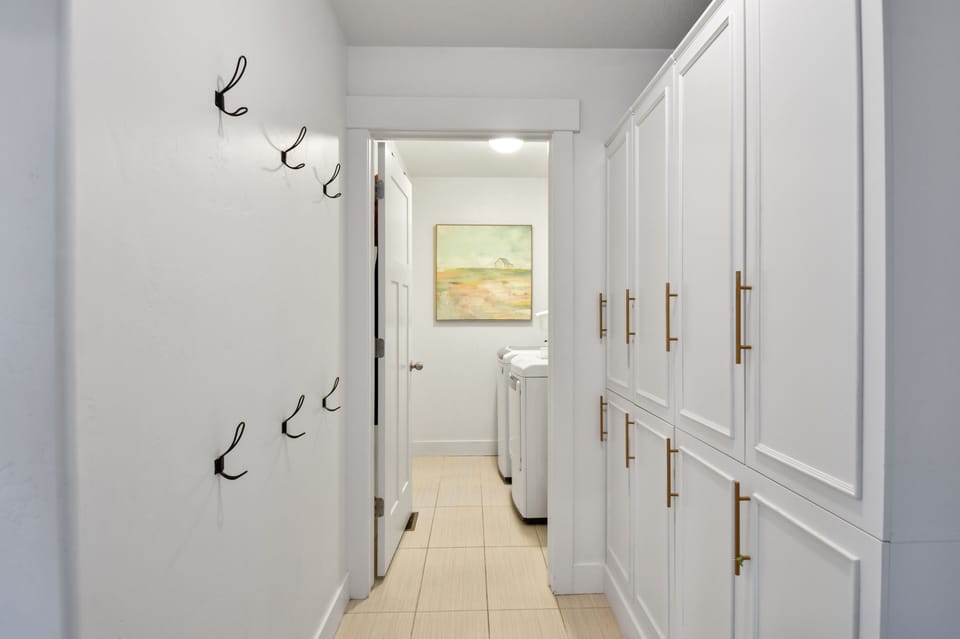 Just off the kitchen is a cute half bathroom that leads to a large mud room / laundry room with plenty of storage for gear.