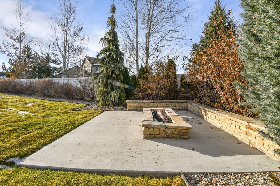 A Large 10 person Arctic Spa in a private backyard with bistro lights and pergola.  The backyard also has a great firepit and huge lush grassy area and large BBQ.